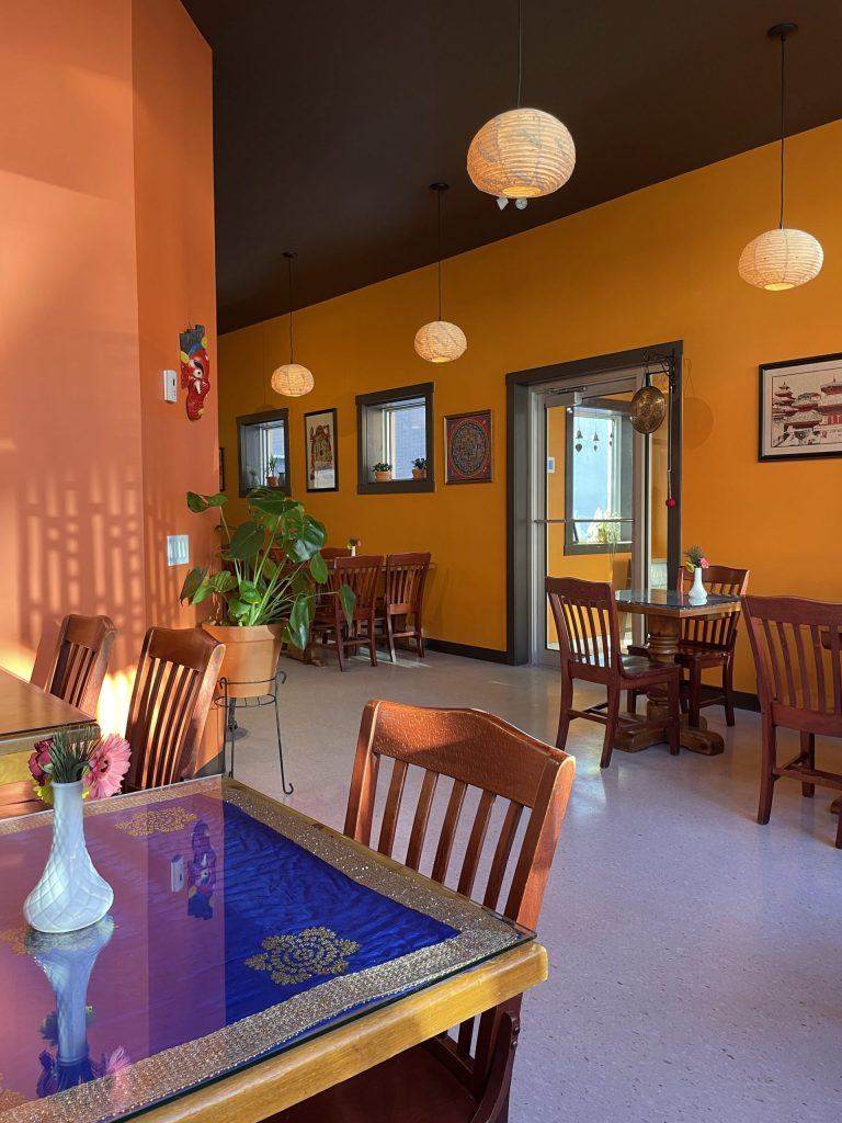 Cozy dining room at Northern Himalayan Cafe with warm terracotta walls